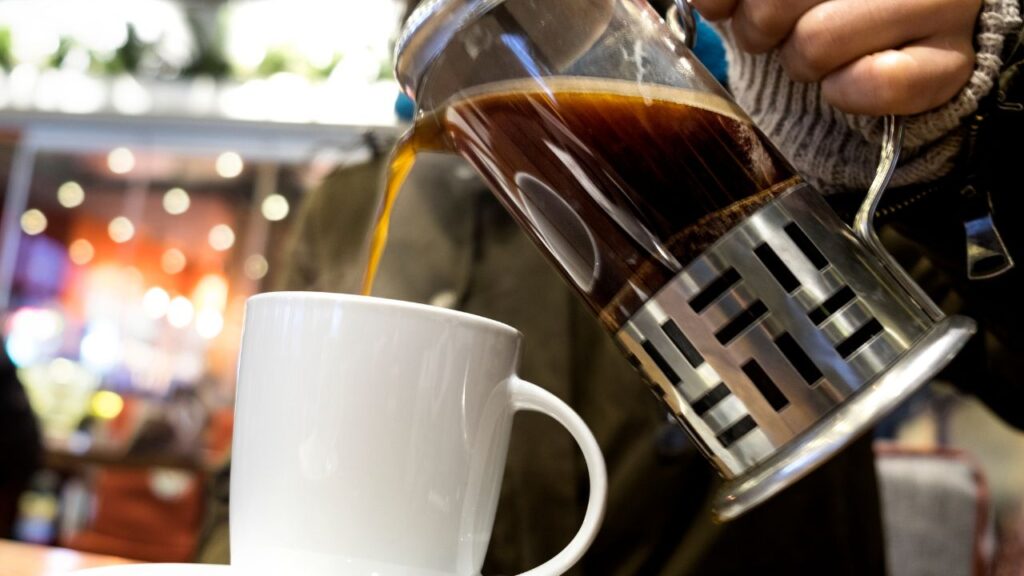 Pour french press coffee into the cup